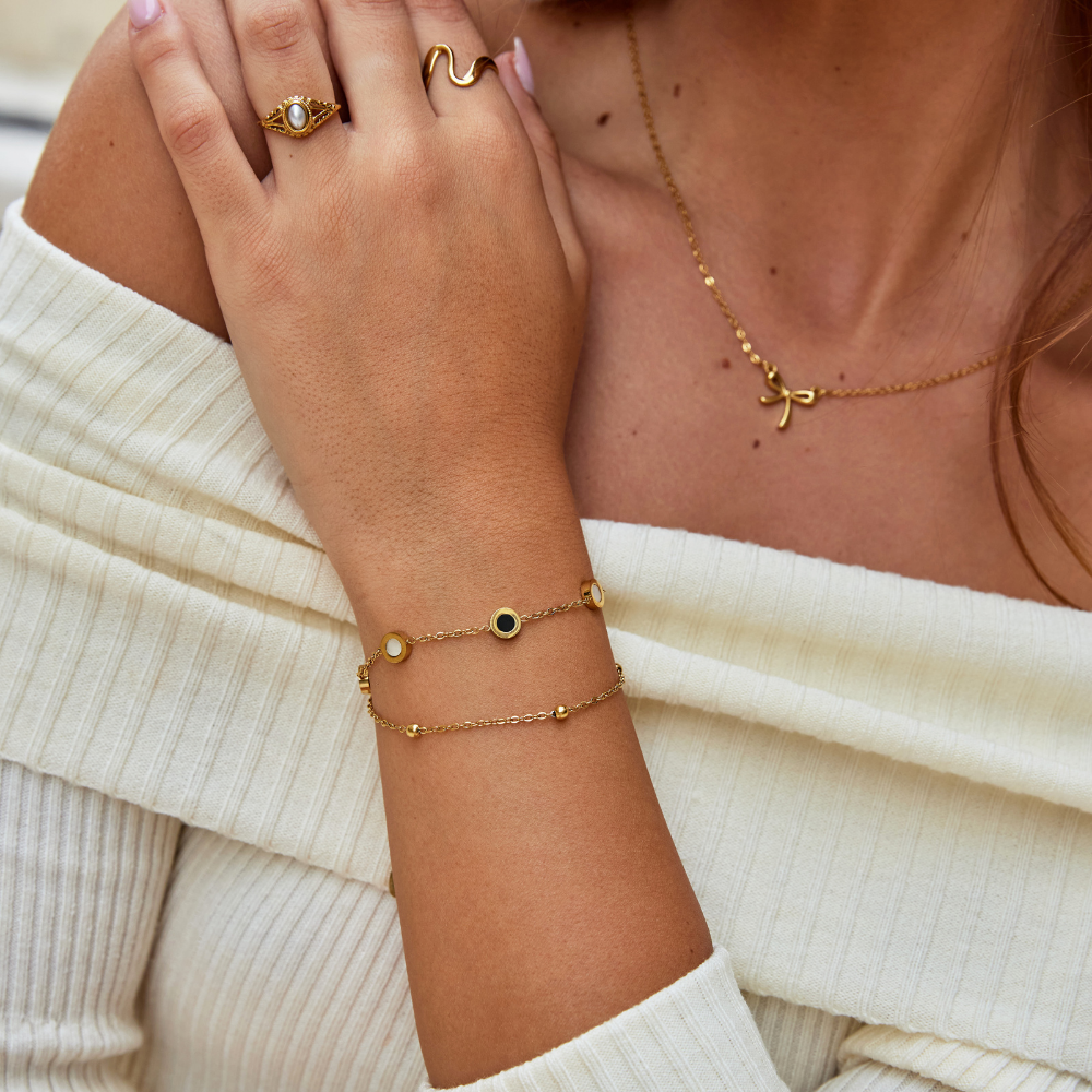 Carla – Bracciale dorato con elementi rotondi morbidi e contrastanti